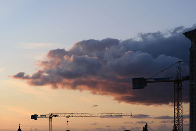 Low angle view of silhouette telephone pole against sky during sunset