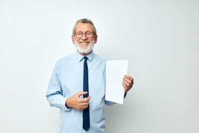 Portrait of businessman standing against white background