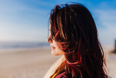 Portrait of woman on beach against sky