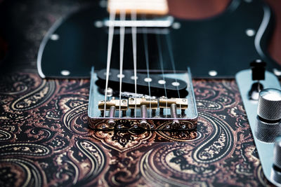 Close-up of guitar on table