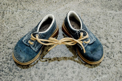 Close-up of shoes on sand