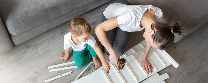 High angle view of mother and son on floor at home