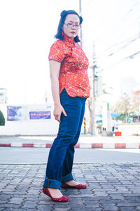 Portrait of young woman standing on street