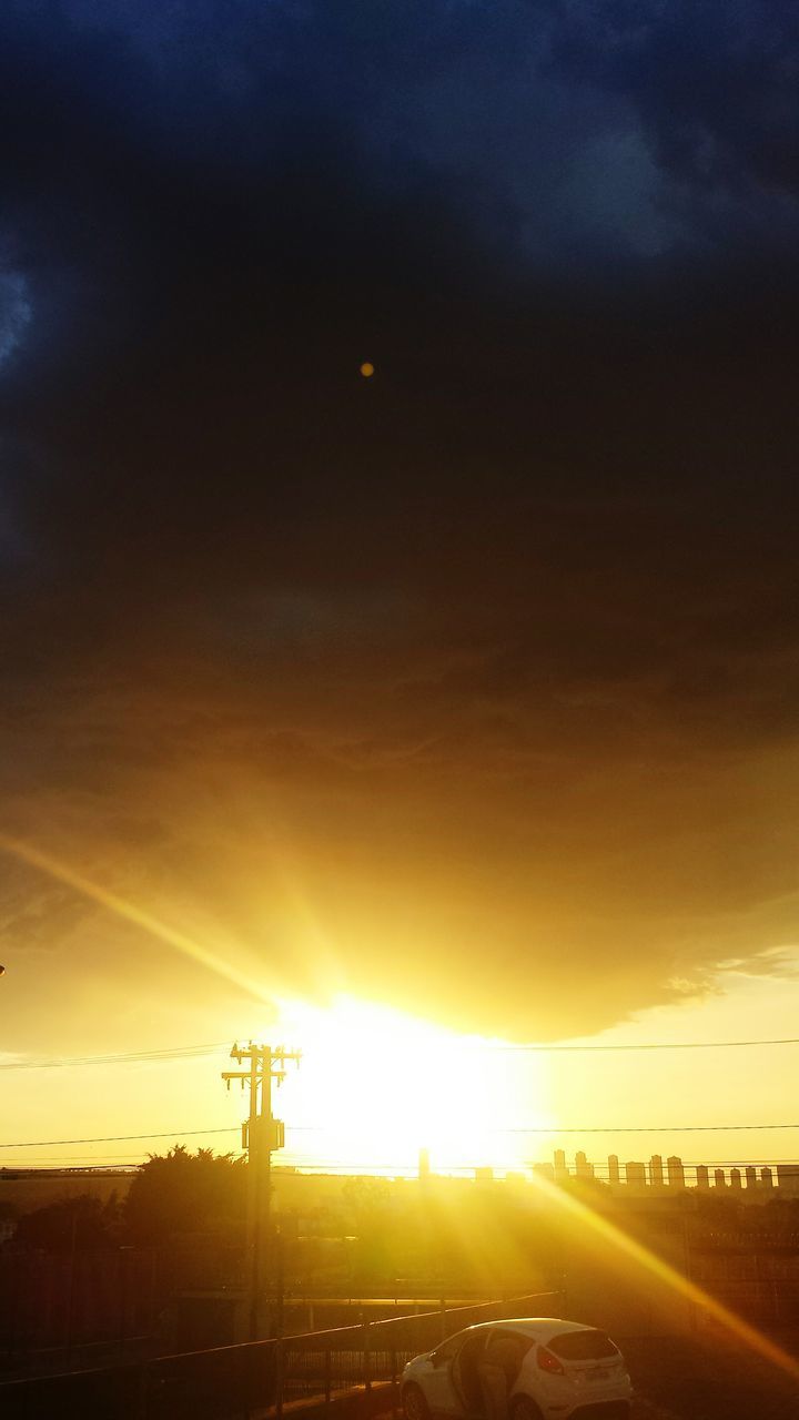 sun, lens flare, sunbeam, sky, sunset, electricity pylon, glowing, power line, environment, dramatic sky, atmosphere, orange color, back lit, bright, power supply, cloud - sky, scenics, atmospheric mood, outdoors, beauty in nature