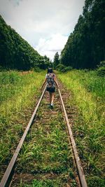 A girl on a train tracks 