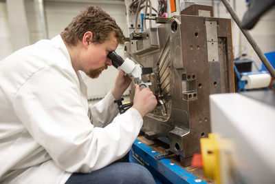 Side view of man working in factory