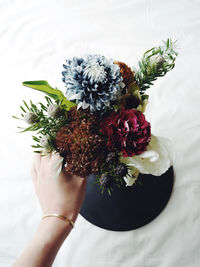 Close-up of hand holding flower bouquet