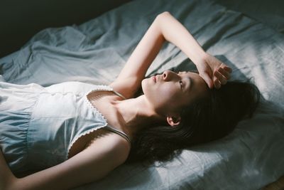 Young woman lying on bed at home