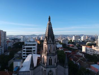 Buildings in city against blue sky