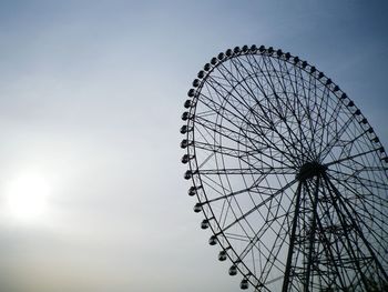 Low angle view of ferris wheel against sky