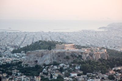 High angle view of acropolis on mountain amidst cityscape