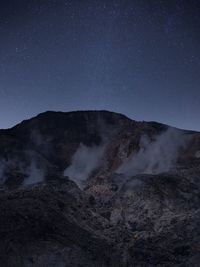 Scenic view of mountains against sky at night