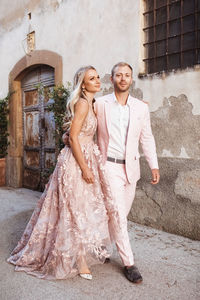 Newlywed couple walking on street