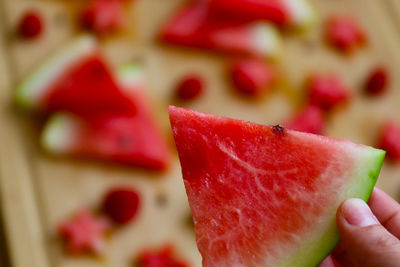 Close-up of hand holding strawberry