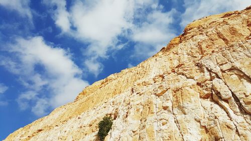 Low angle view of rock formation against sky