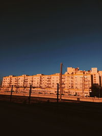 Low angle view of buildings against clear blue sky