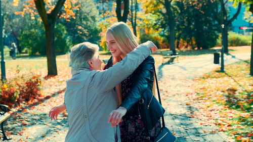 Woman sitting in park during autumn