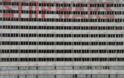Abandoned building facade with graffiti slogan - stop wars. berlin