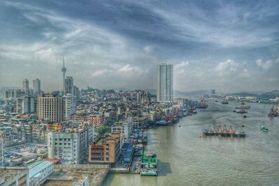 Cityscape against cloudy sky