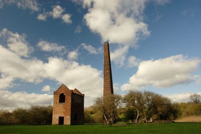 Old building in field against sky