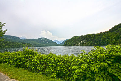 Idyllic shot of river and green mountains against sky