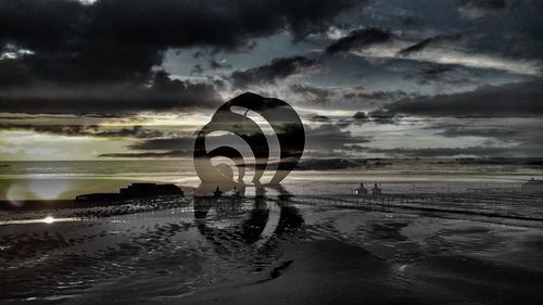 Scenic view of beach against sky during sunset