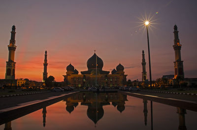 Facade of an nur great mosque against sky during sunset