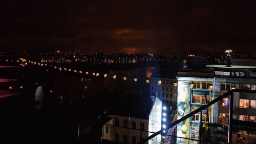 High angle view of illuminated buildings in city at night