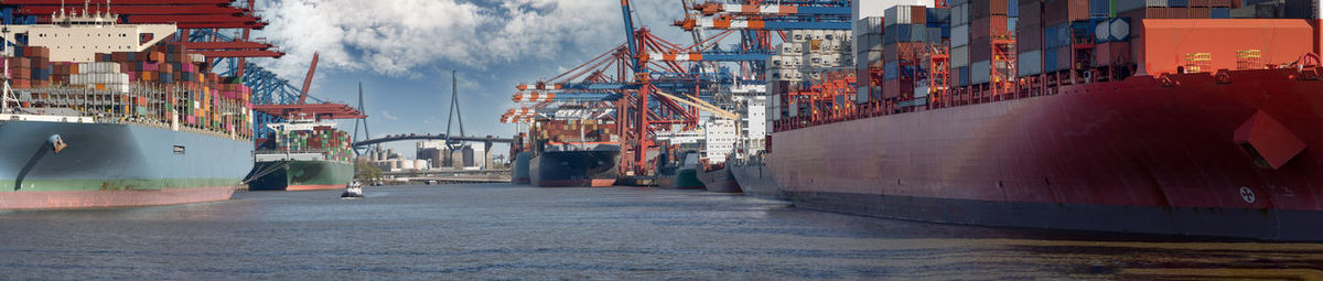 Panoramic view of commercial dock against sky