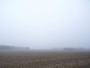 Scenic view of landscape against sky during foggy weather