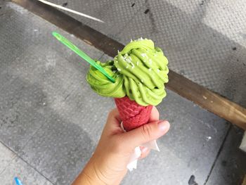 High angle view of hand holding ice cream