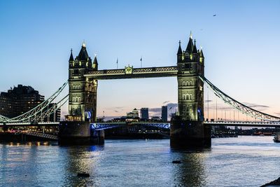 Bridge over river with city in background