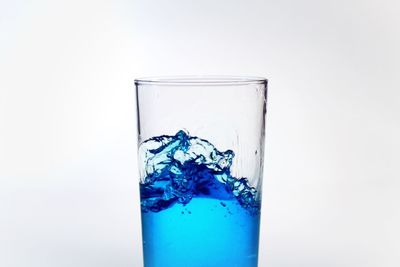 Close-up of blue water over white background