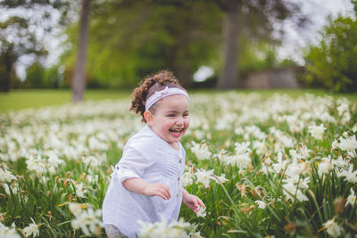 Portrait of happy girl in grassy field
