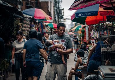 People on street market in city