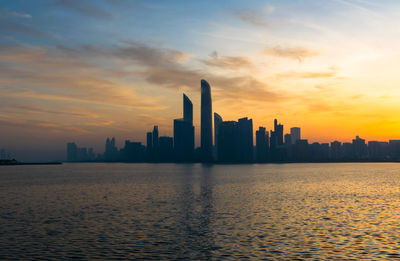 Buildings in city during sunset