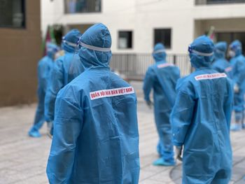 Rear view of people working on street