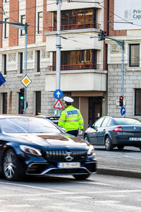 Vehicles on road against buildings