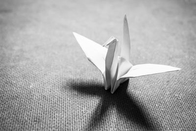 Close-up of paper crane on table