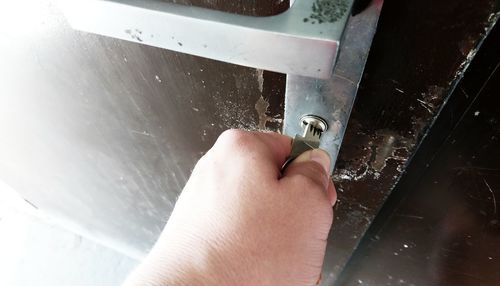 High angle view of man working on metal