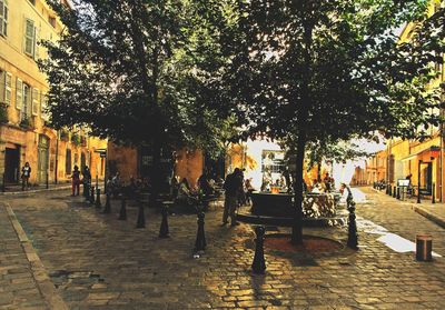 Group of people walking on sidewalk in city