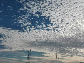 Low angle view of electricity pylon against sky