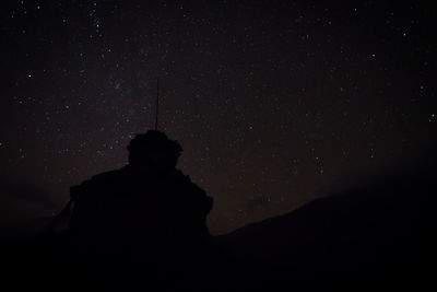 Low angle view of silhouette trees against sky at night