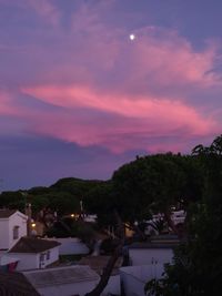 High angle view of trees and houses against sky at sunset