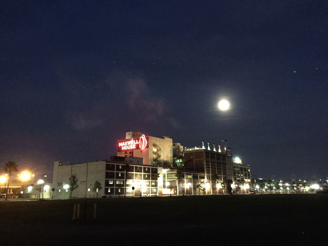 night, illuminated, building exterior, architecture, built structure, sky, city, moon, lighting equipment, street light, dark, outdoors, light - natural phenomenon, building, copy space, residential building, dusk, no people, low angle view, cityscape