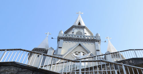 Low angle view of church against clear blue sky