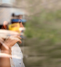 Close-up of hand holding smart phone outdoors