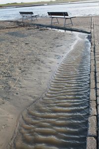 High angle view of tire tracks on beach