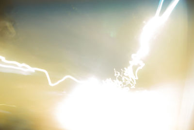 Lightning in sky during sunny day