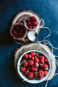 High angle view of strawberries in glass jar on table